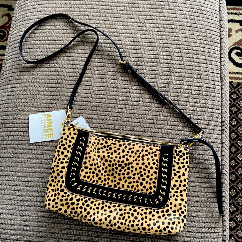 Leopard print fur and black leather small purse.